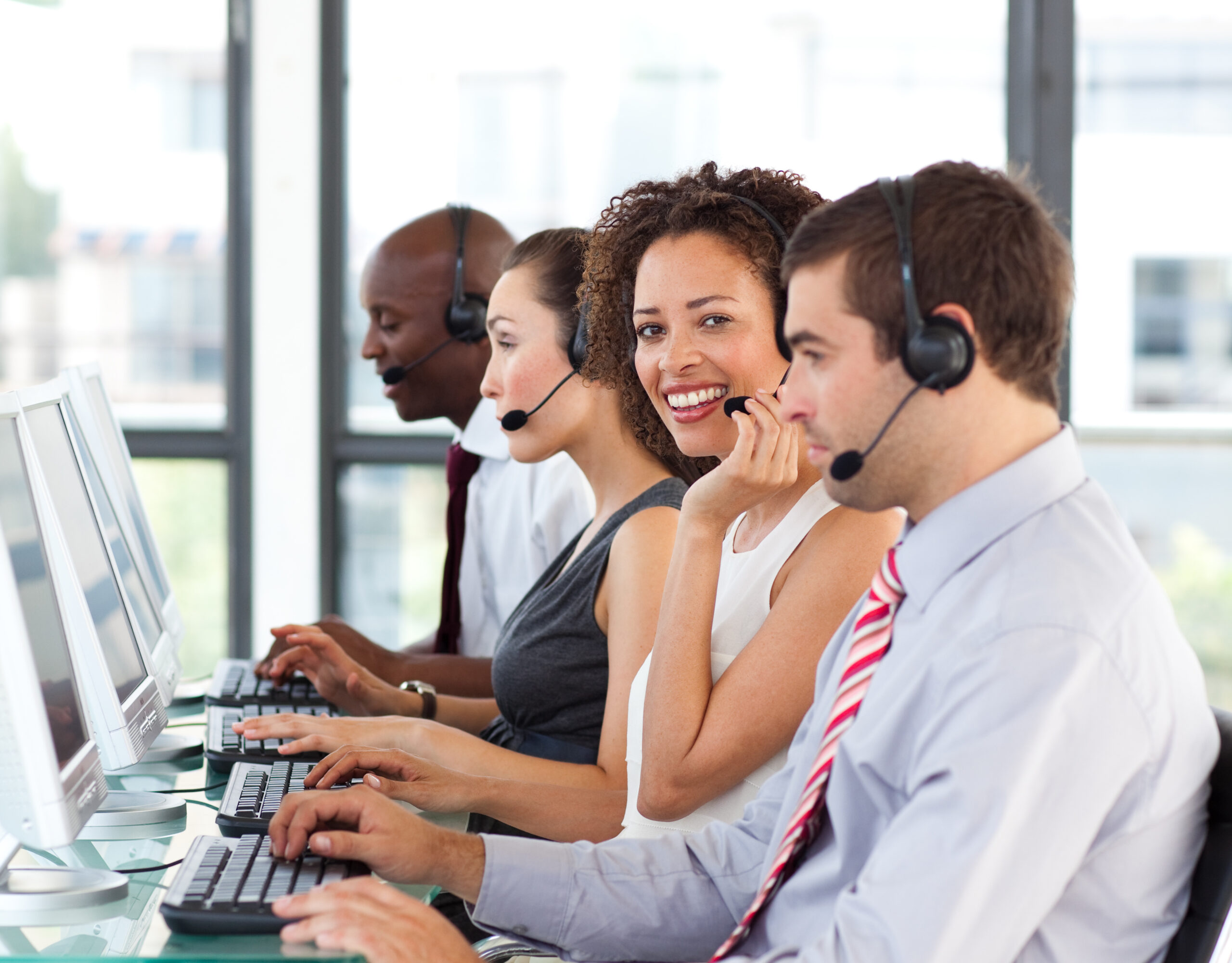 Smiling young businesswoman working in a call center
